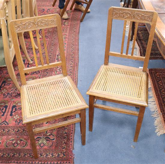 A set of six early 20th century carved oak cane seated dining chairs